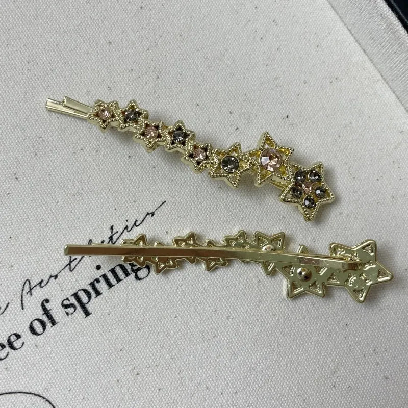 Gold electroplated alloy rhinestone barrette with star charm decoration