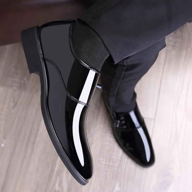 Men's black and brown formal slip-on shoes with round toe and square heel on a rubber sole.
