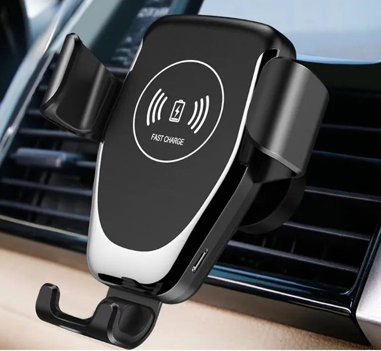 Black car wireless charger mount holding Apple iPhone with automatic clamping arms on car dashboard