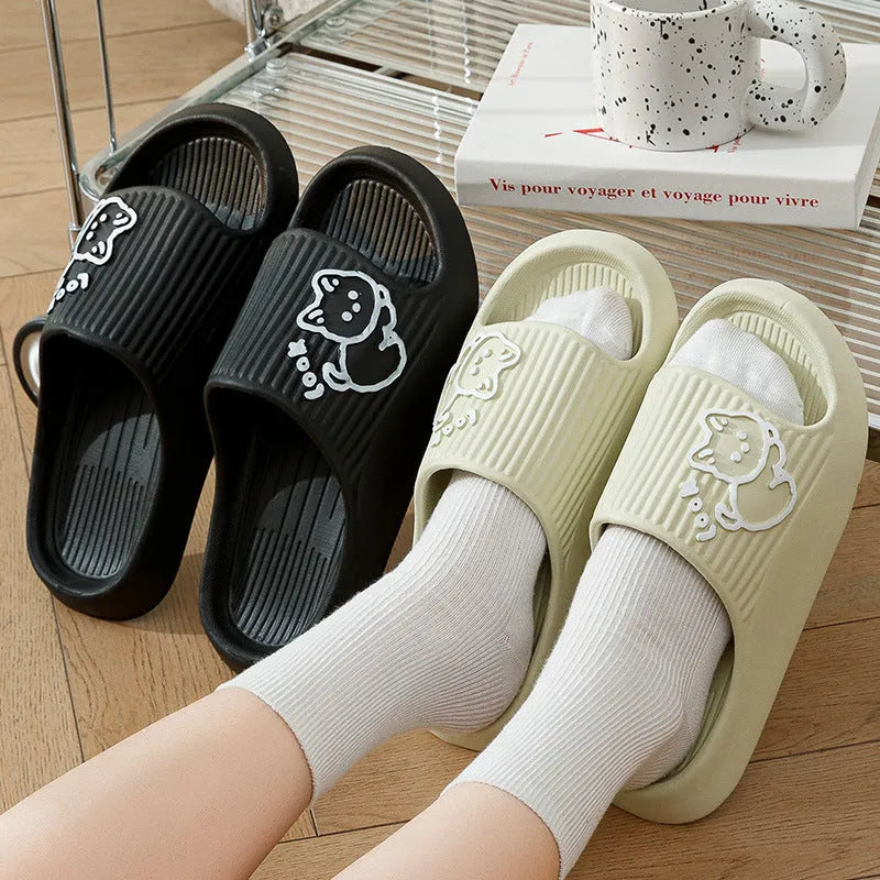 Green cat slippers with a thick EVA platform and non-slip sole on a wooden floor.