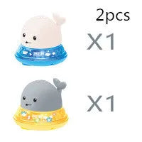 Electric whale bath toy with automatic water spray and flashing lights on a base
