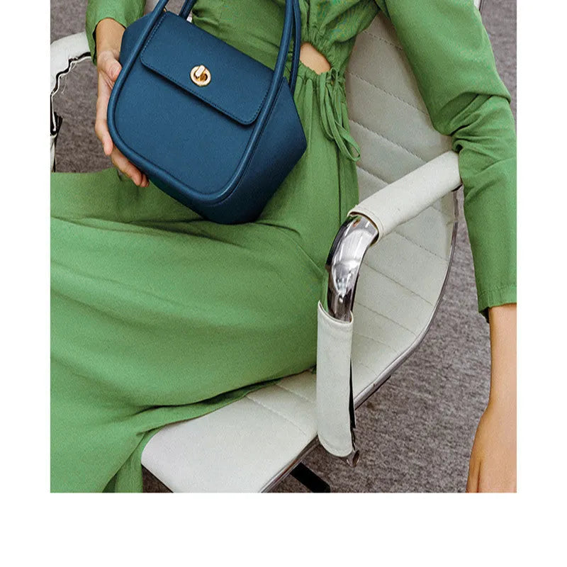 Women's leather wing handbag in blue with buckle decoration and shoulder strap