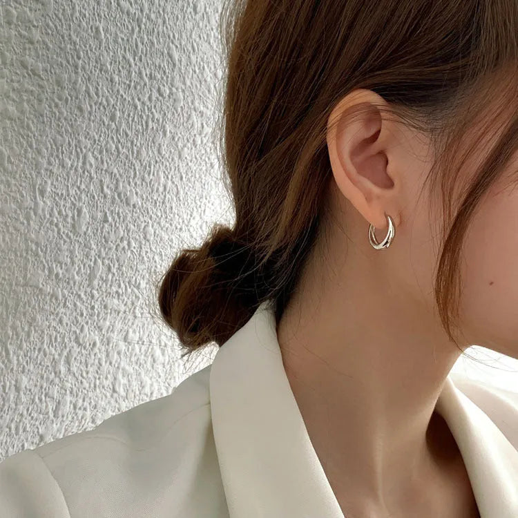 Women's minimalist water drop earrings in electroplated gold or silver copper, showing geometric shape and round elements.