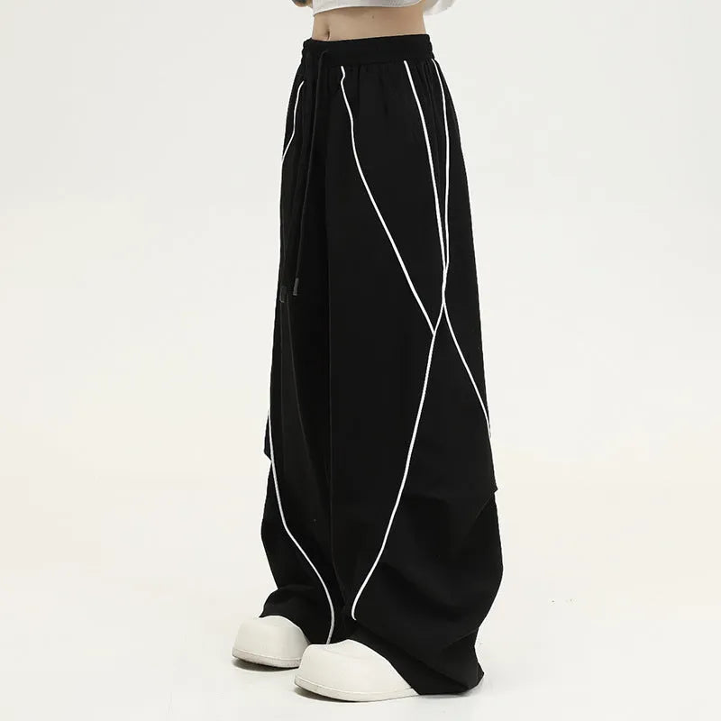 Black striped hip hop trousers with wide-leg pleated design showing mid-waist styling