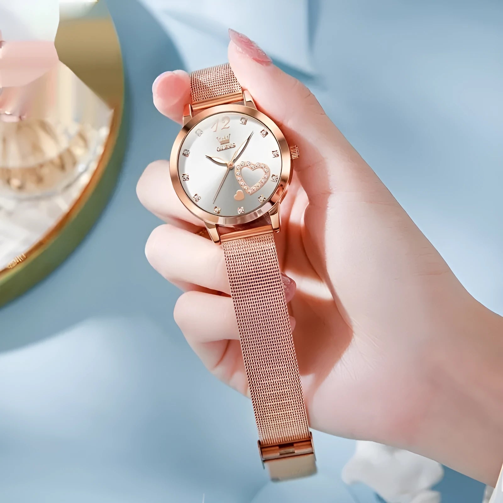 Women's fashion watch with rose-coloured alloy case and mesh strap showing coloured dial options