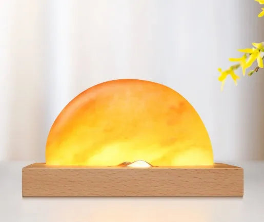 Sunrise Oriental wooden base table lamp with natural salt block shade and integrated wireless phone charging pad.