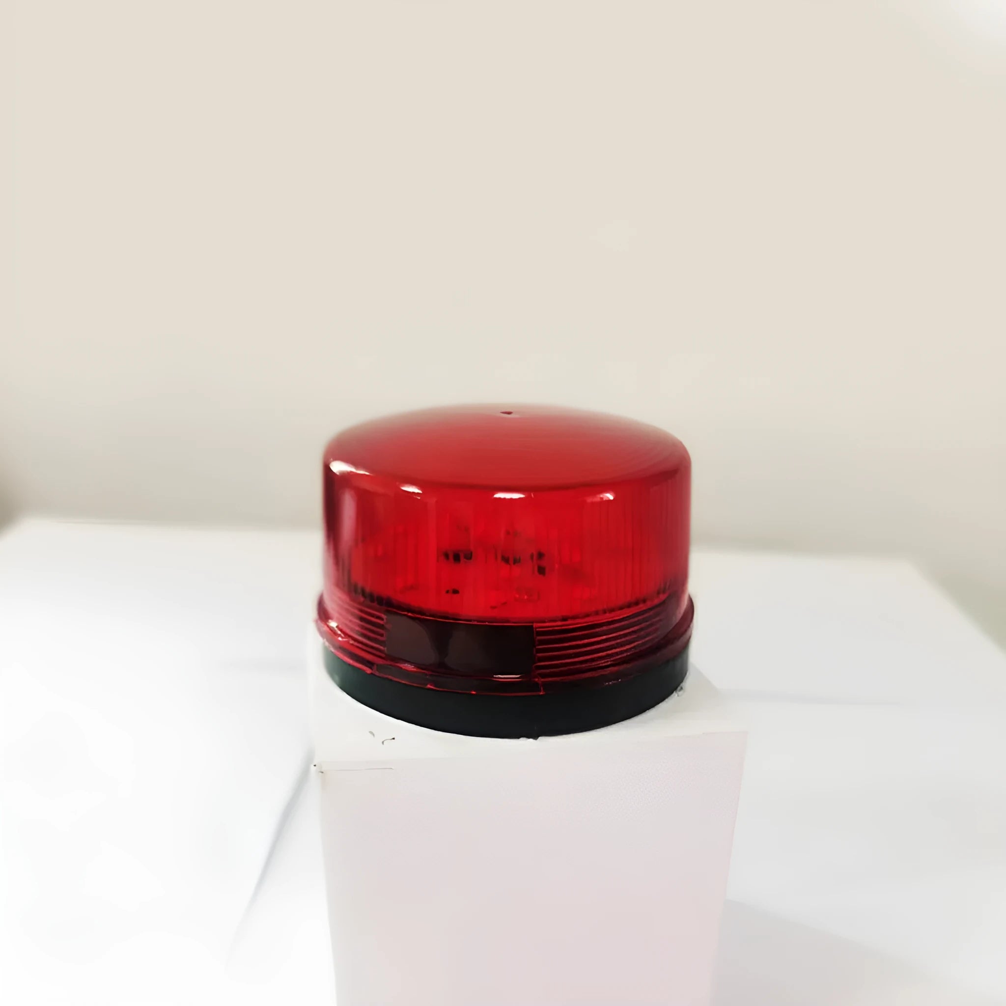 Small cylindrical warning alarm light with flashing beacon and audible alert for fire protection systems