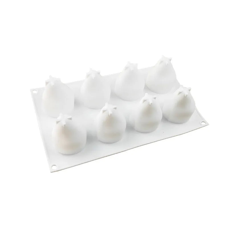 Six-cavity silicone baking mould showing pineapple and pine cone shapes