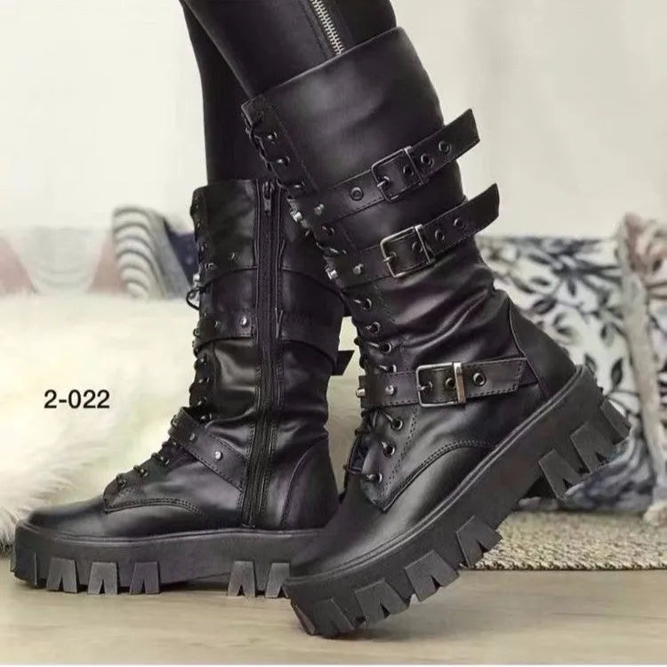 Women's black mid-calf knight boots with a metal buckle and side zipper on a chunky sole.