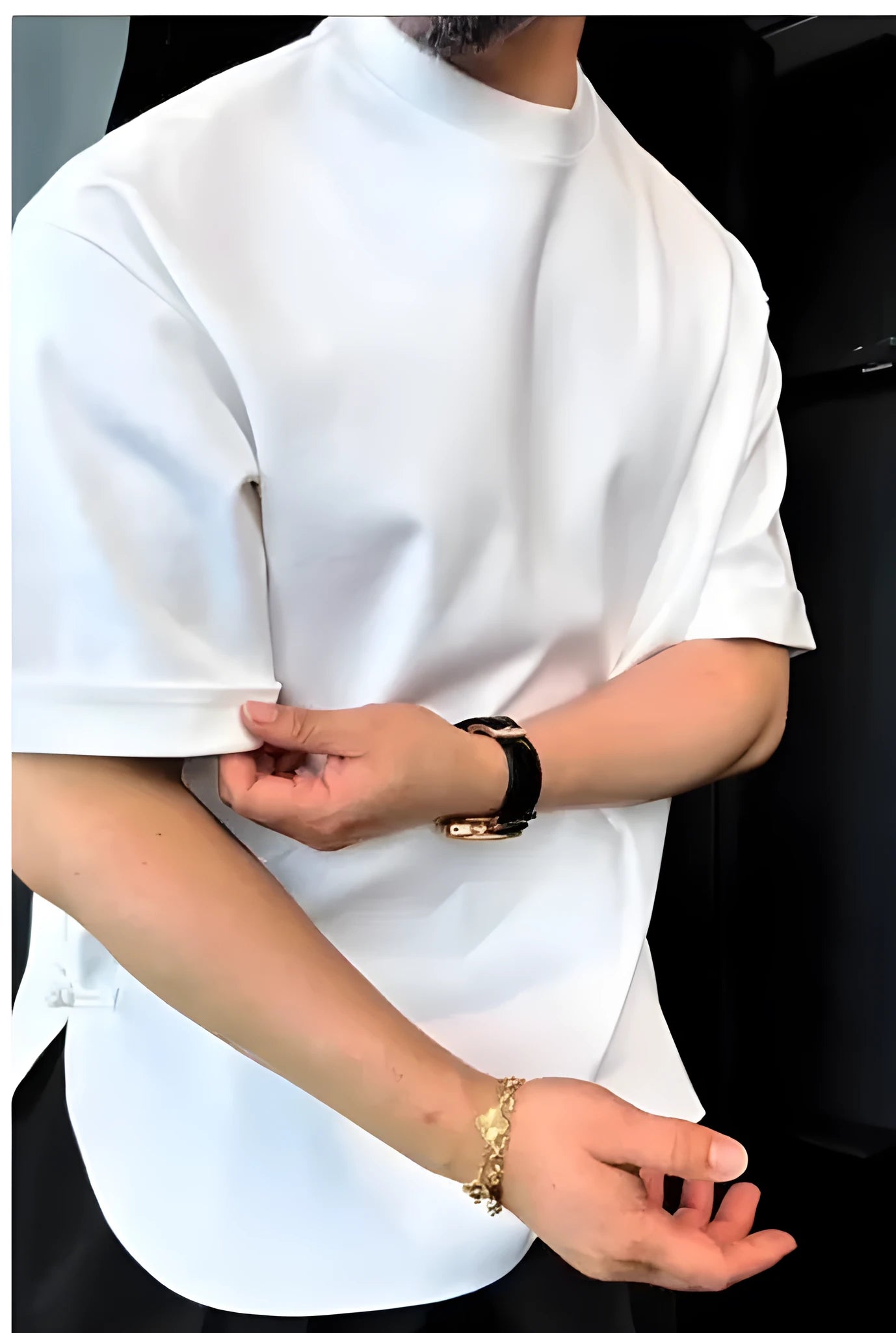White men's cotton t-shirt with decorative buttons on the front and sleeves, showing a round hem.