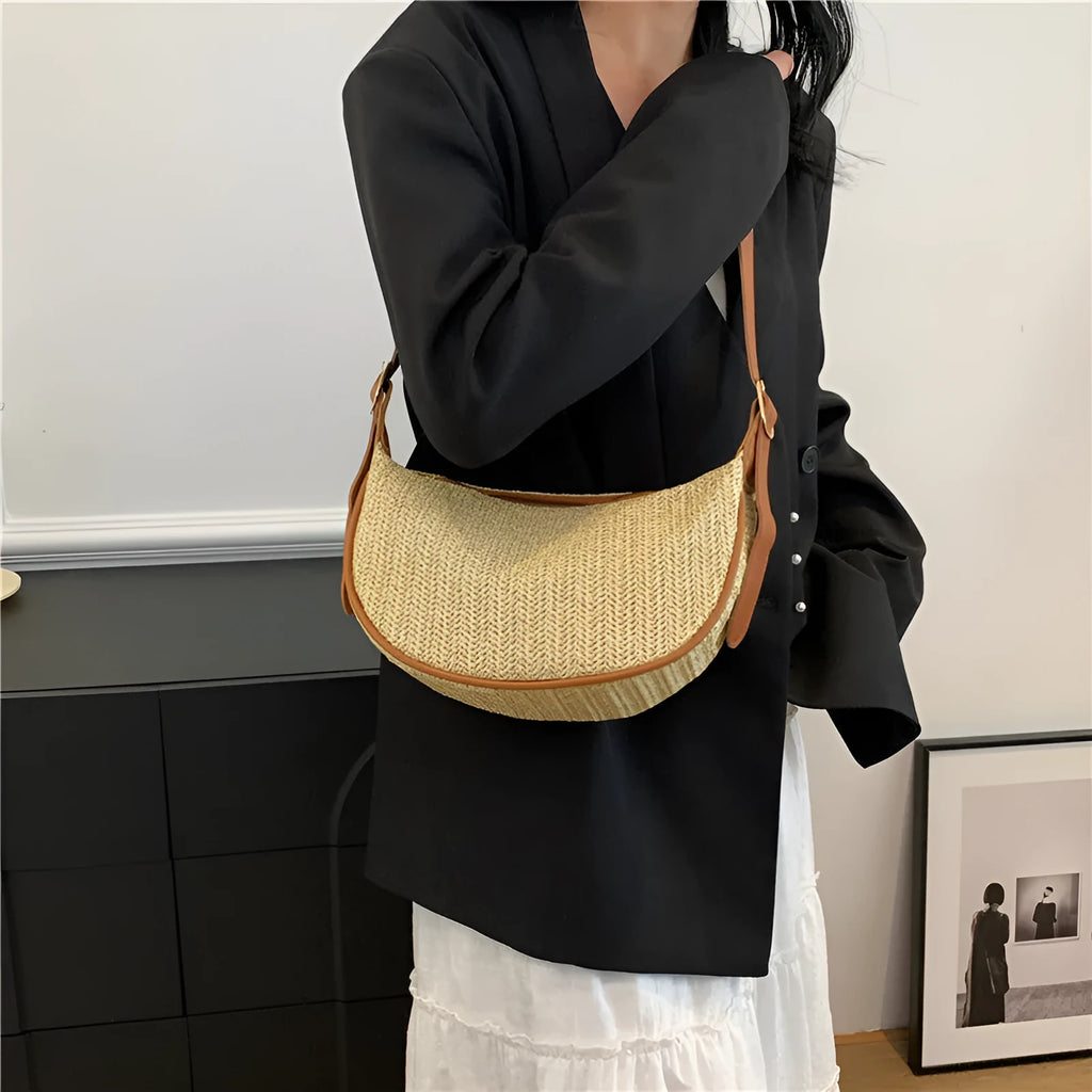 Women's woven straw crossbody bag showing internal phone compartment and file pocket in milky white colour
