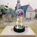 Small glass cover night lamp with plastic flower decoration showing warm golden light illumination