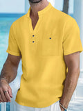 Man wearing a light apricot-coloured linen blend T-shirt with a stand collar and short sleeves.