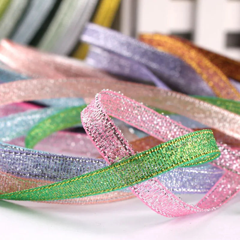 Roll of 0.6cm wide coloured polyester ribbon in onion-dye shades for clothing and gift packaging