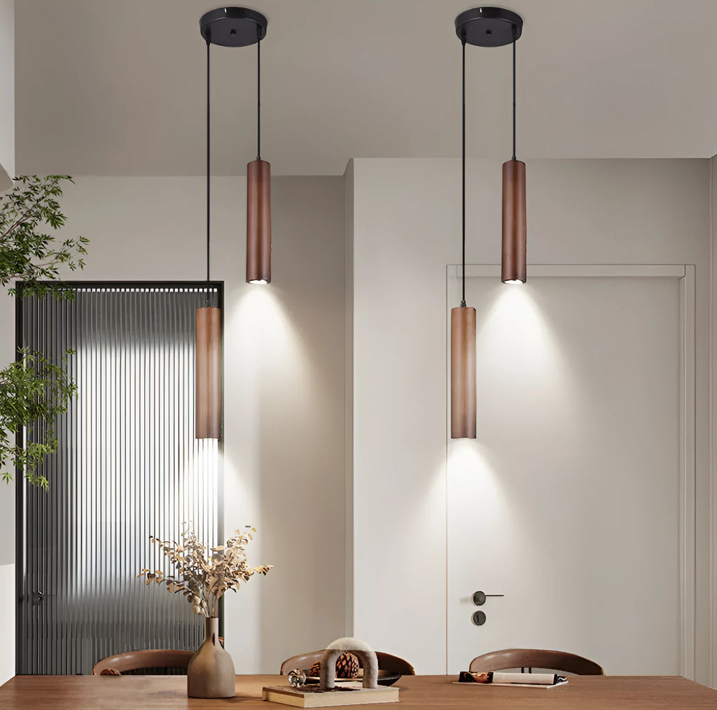 Solid wood Japanese style long chandelier with three warm light droplights in a modern bedroom