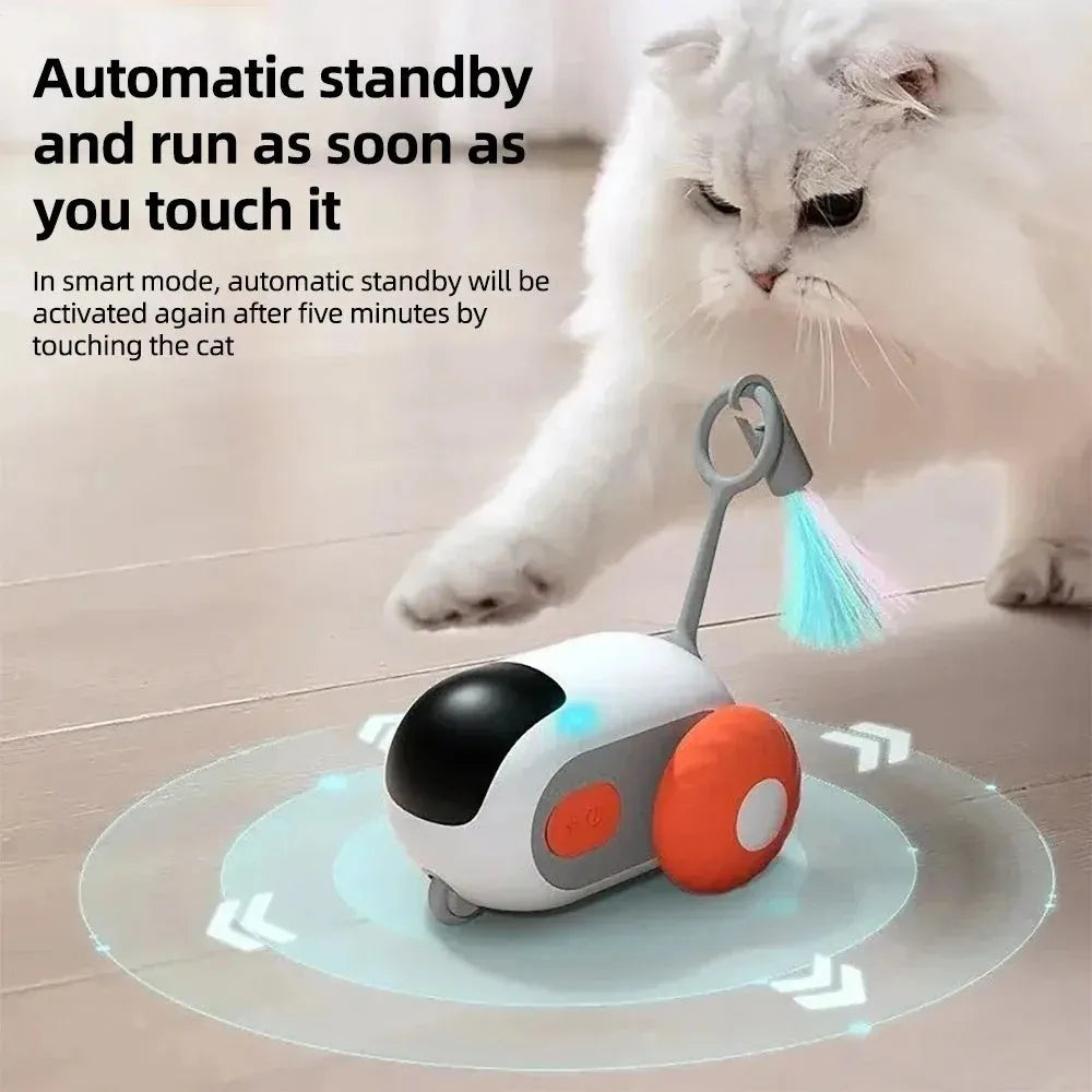 Blue remote-controlled cat toy car with feather attachment on hardwood floor