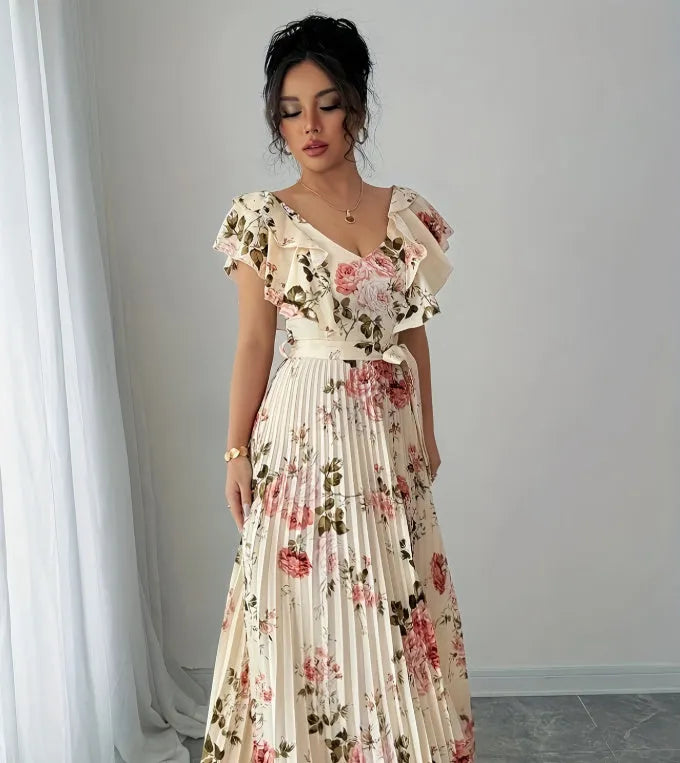 Apricot V-neck dress with digital floral print, ruffled short sleeves, and oversized pleated swing skirt.