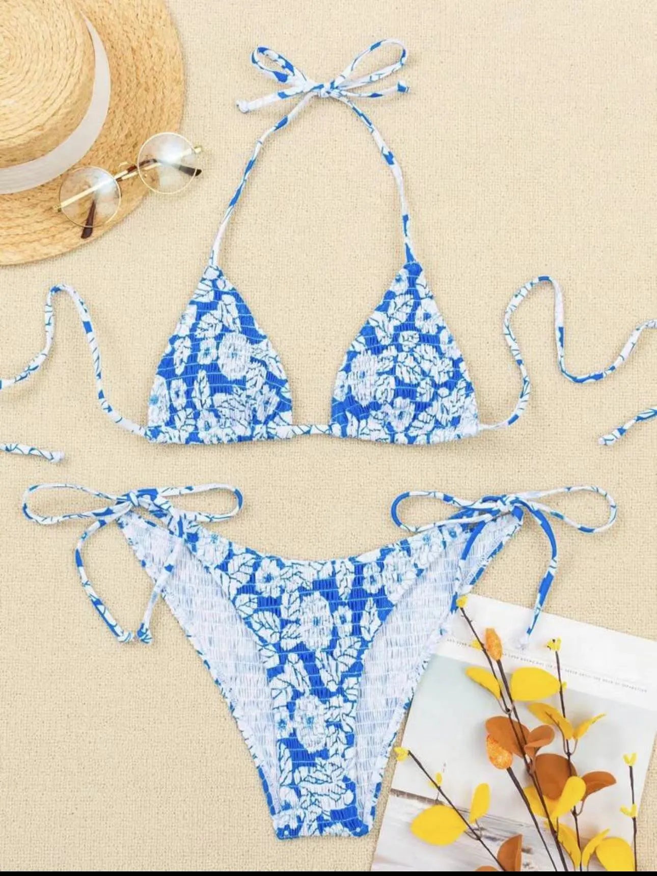 Women's floral halter neck two-piece swimsuit in light blue on a mannequin.