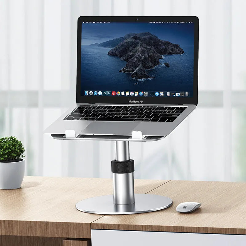 Silver adjustable laptop stand with 360-degree rotating base on a wooden desk.