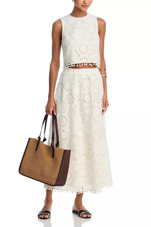 White women's sleeveless top and long skirt suit set with embroidery detailing