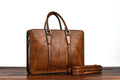 Men's brown leather business handbag with horizontal square shape and zipper closure