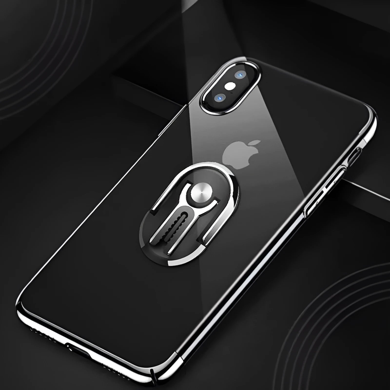 Black car phone bracket mounted on air vent with phone secured, showing adjustable ball mechanism