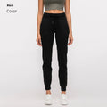 Women's high waist black yoga pants with drawstring detail, shown on a model.