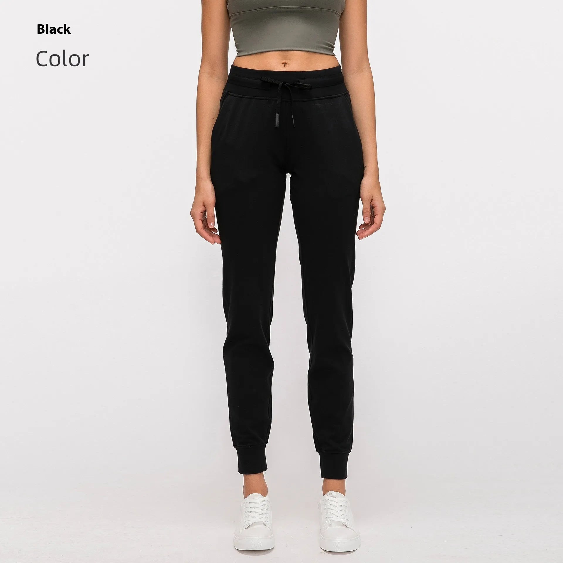 Women's high waist black yoga pants with drawstring detail, shown on a model.