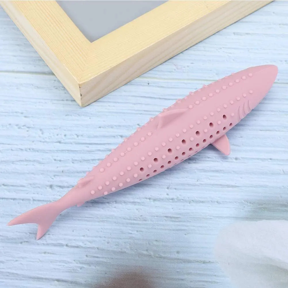 Green silicone fish-shaped cat chew toy with side holes on a white background