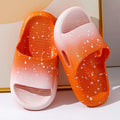 Gradient blue children's PVC summer slippers with a non-slip sole on a wooden deck.