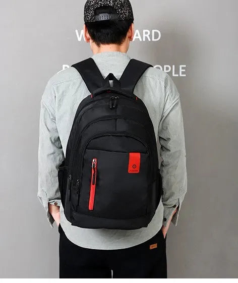 Oxford fabric school backpack with reinforced straps and side pockets available in blue green red grey and orange for teenagers