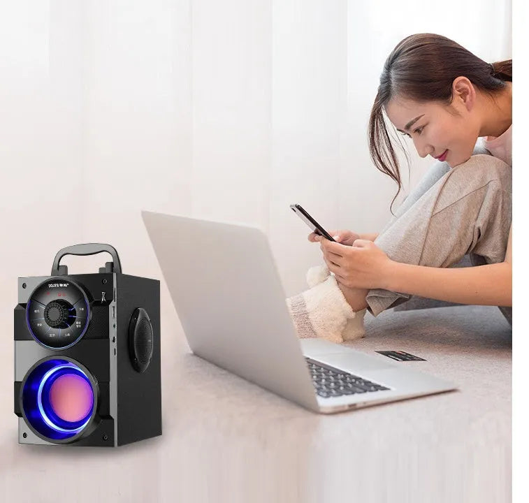 Black portable mini home audio system with subwoofer, connection cable, and charging accessories