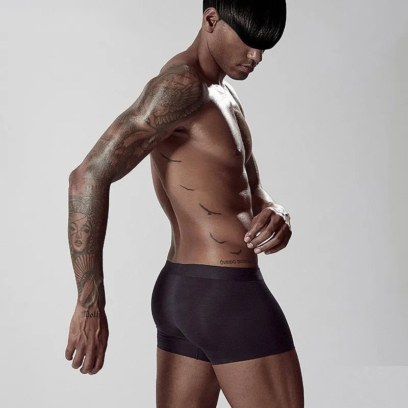 Men's seamless one-piece modal underwear in green, shown flat, highlighting its mid-waist and solid colour design.