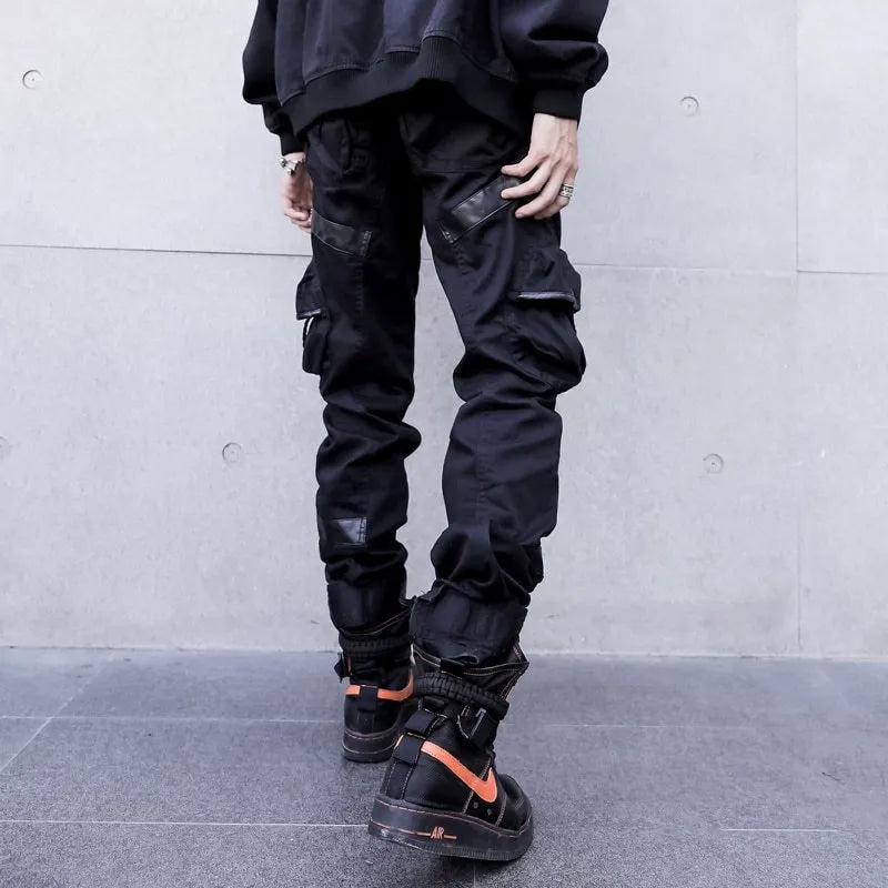 Black men's leather pocket splice cargo trousers with harem cut and long legs