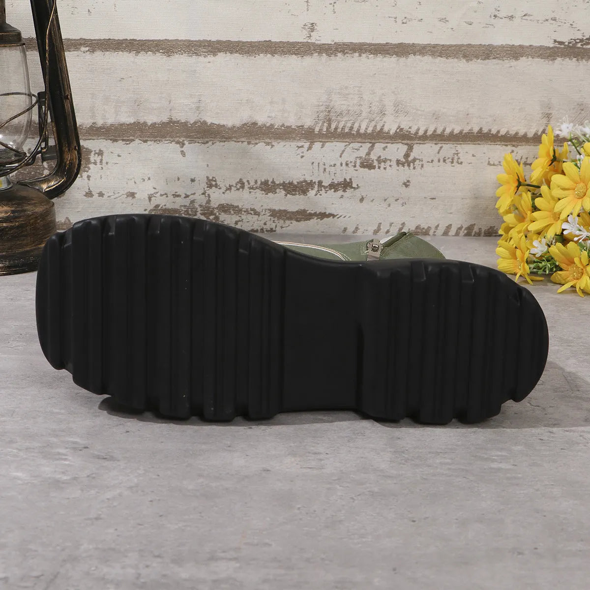 Women's black platform Martin boots with chunky heel and side zipper on a white background.