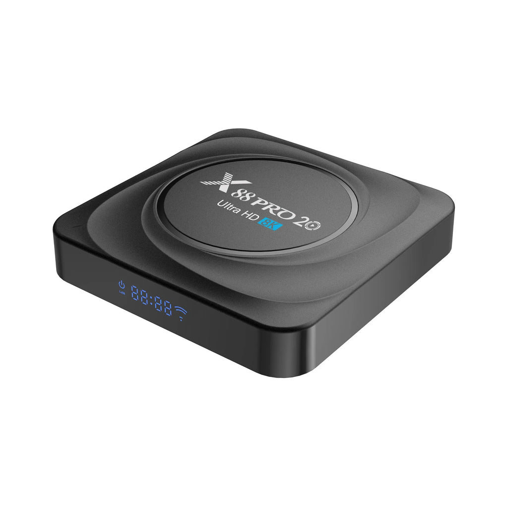 Compact black Android TV set-top box with remote control and HDMI cable on a wooden surface.