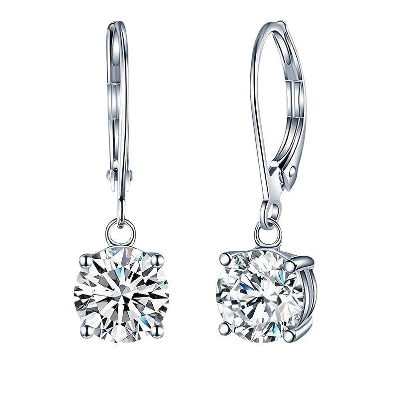 Silver colour zircon earrings with genuine stones and secure metal fastening on a white background