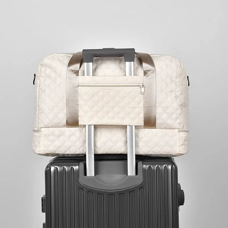 Large grey and pink Oxford cloth leisure travel bag with sewing thread detail on a white background.