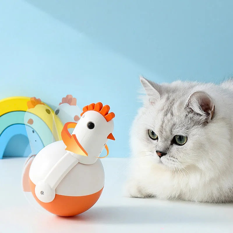 Green or orange electric cat toy chicken with laser and sound features on a flat surface.