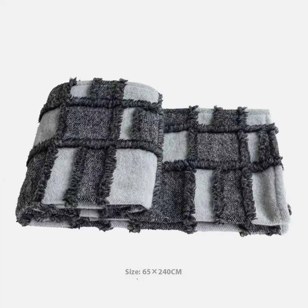 Modern grey and white plaid bed runner blanket set with a pillowcase and leather round pillow on a 1.5m bed.