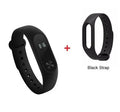 Xiaomi Mi Band 2 black fitness tracker on wrist showing OLED screen with heart rate data