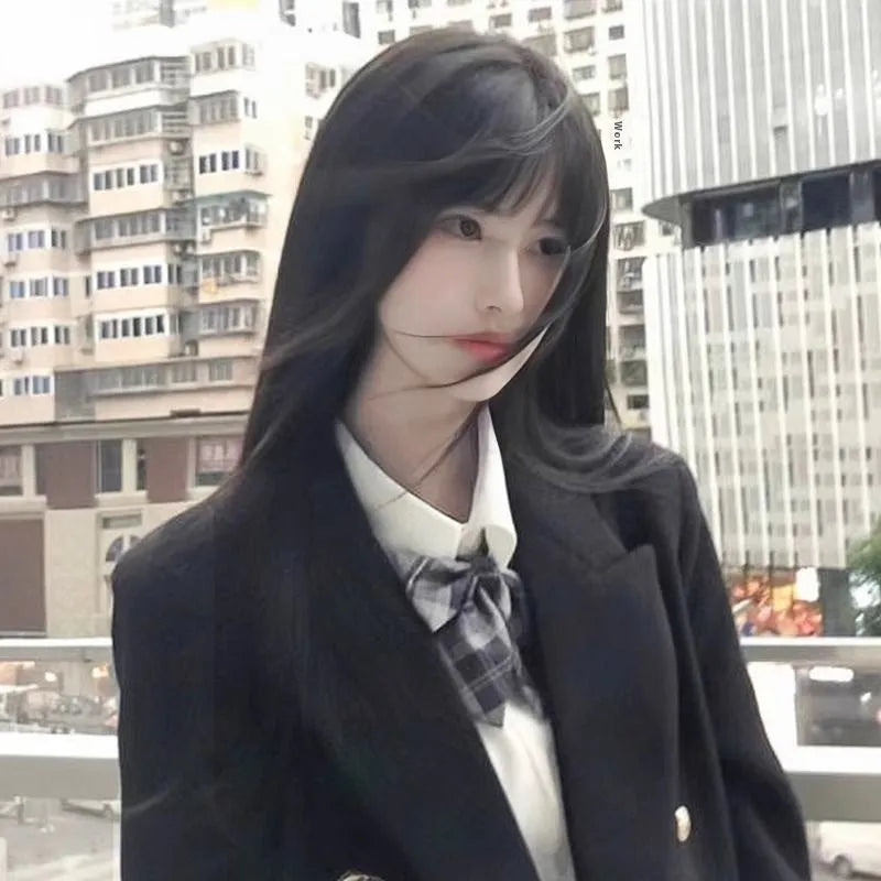 Long straight synthetic wig with bangs in brown-black colour on display