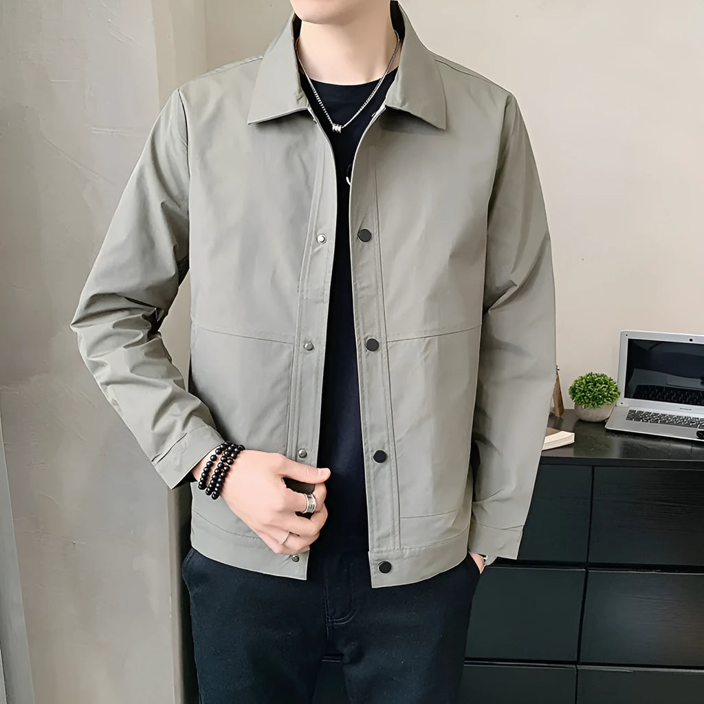 A man wearing a thin, single-layer Korean-style jacket in light grey, suitable for spring or autumn.