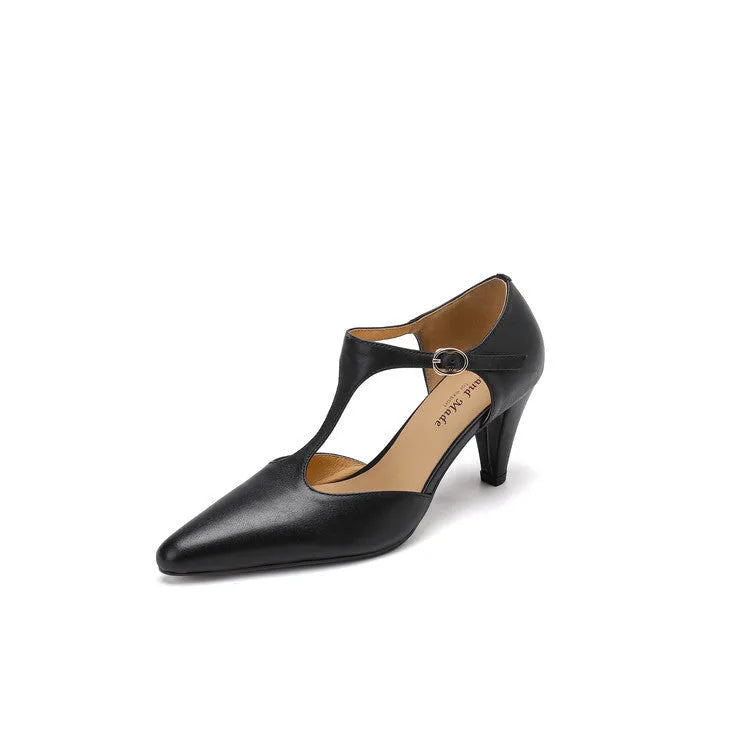 Brown retro women's T-strap closed toe sandals with a stout heel on a wooden surface.