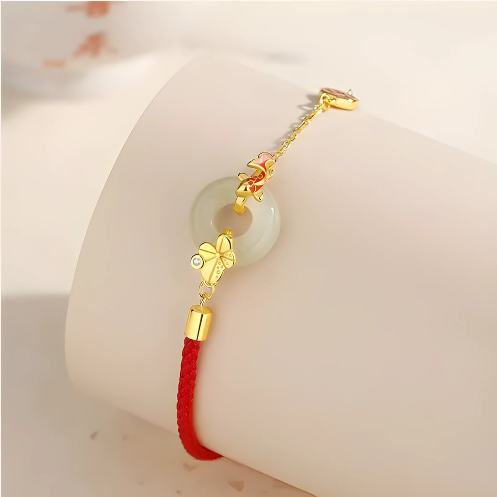 Women's 925 silver bracelet with gold electroplated peace buckle, koi fish charm, and adjustable red rope.