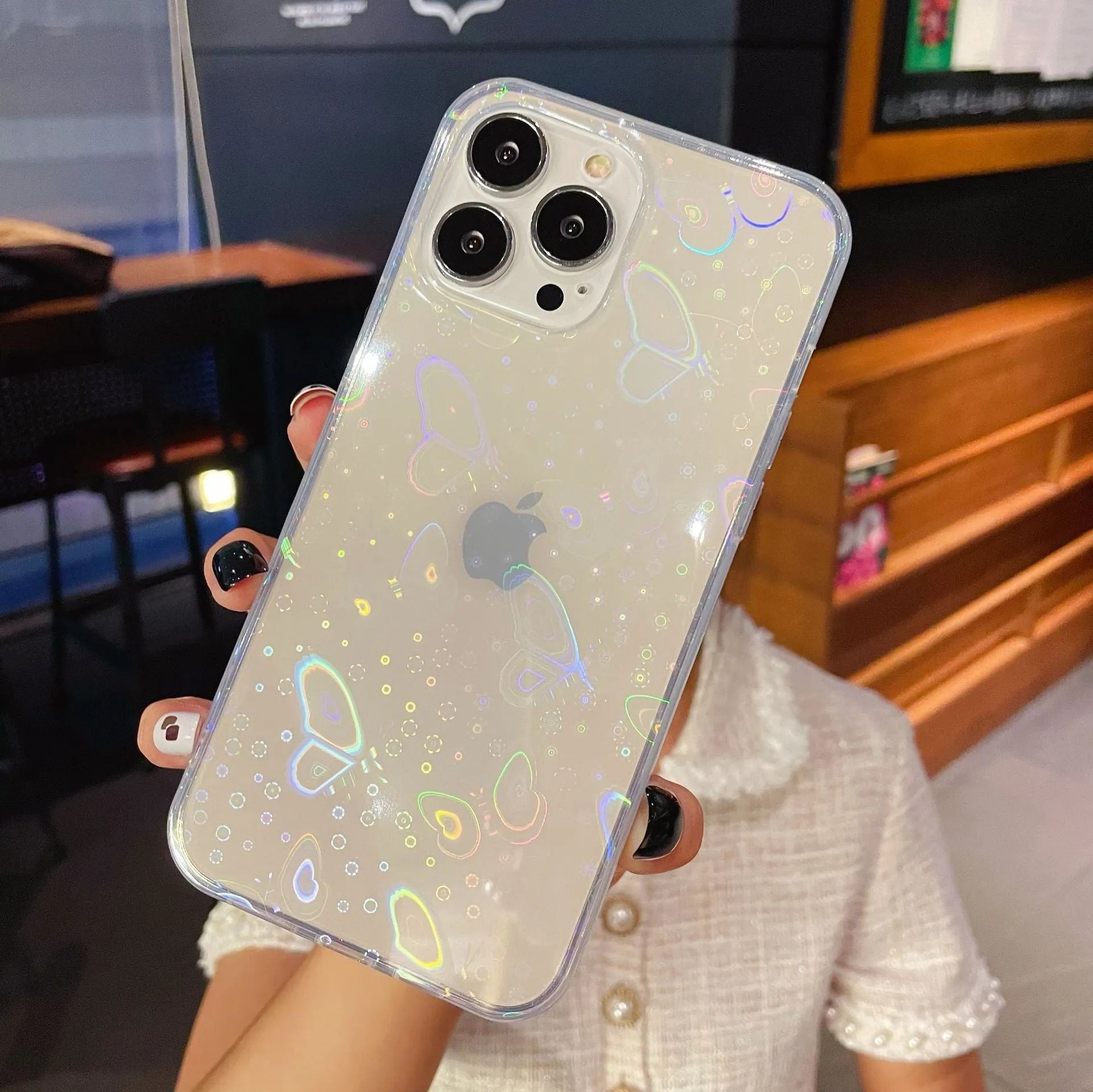 Transparent silicone iPhone case with laser-etched Love design shown on iPhone model