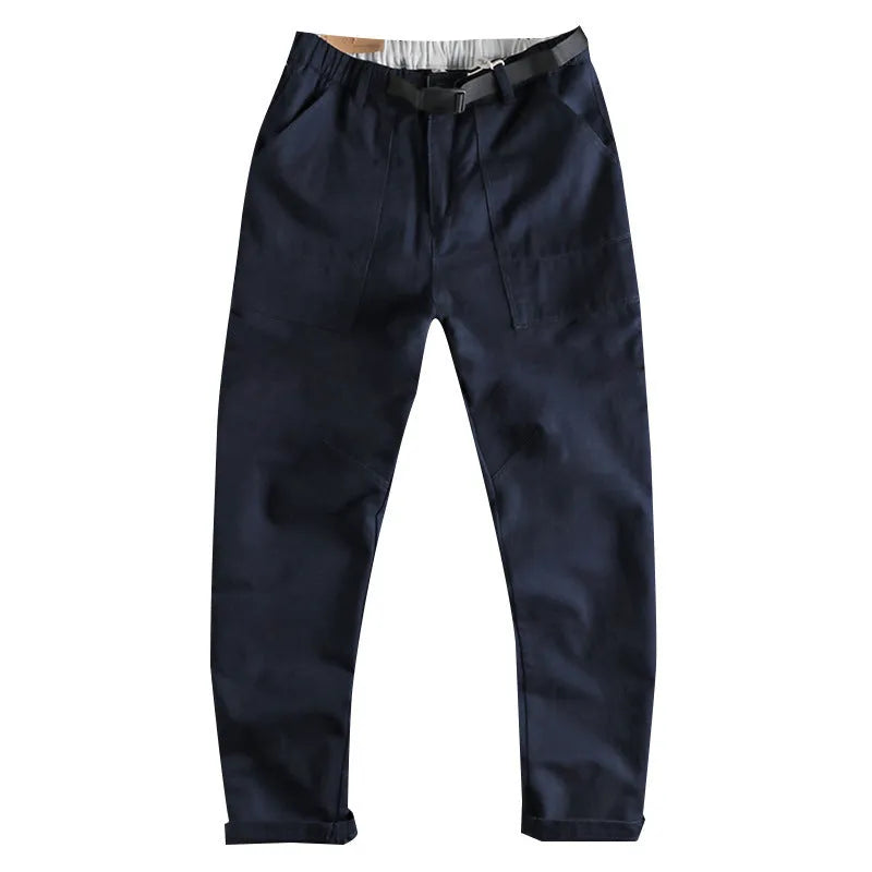 Men's khaki cotton work trousers with N I buckle belt showing three-dimensional cutting detail