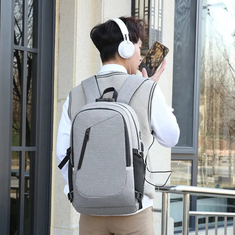 Street-style grey Oxford cloth computer backpack with 20-35 litre capacity for daily use.