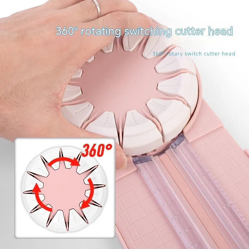 Pink 12-in-1 paper cutting machine with interchangeable blades for scrapbooking on white background