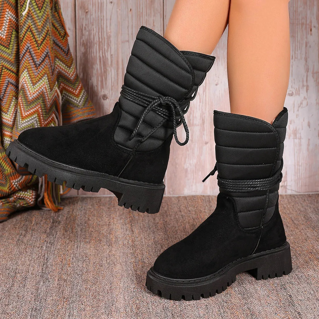 Women's black suede chunky heel snow boots with lace-up design and high top.